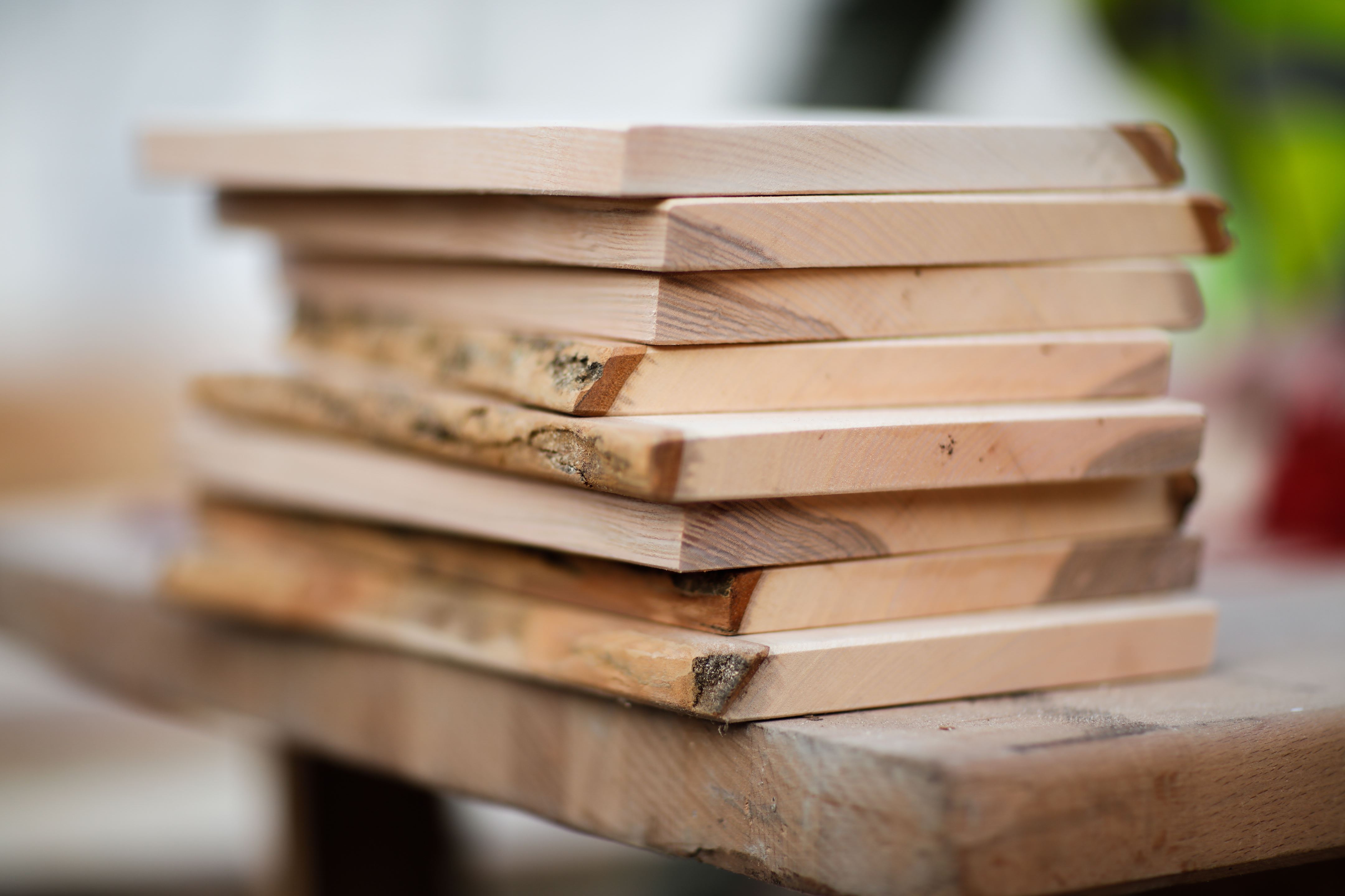 Wooden plank stack lying on table at angle 